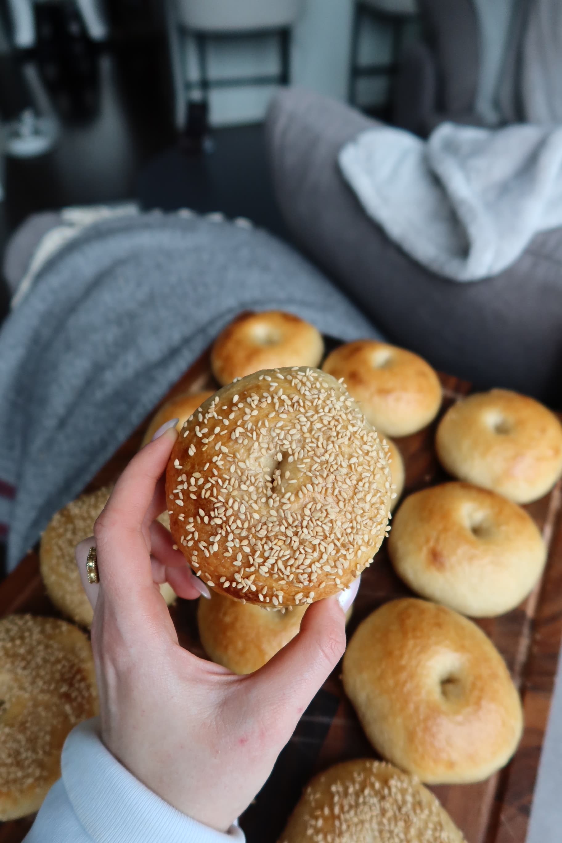 Hand holding sesame bagel overhead